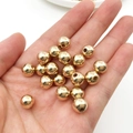 Set of golden CCB spacer beads for DIY jewelry making held in a hand for size scale - KC Gold 8mm (2000Pcs)