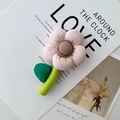 Pink plush flower knit handbag with green stem and brown center on lifestyle magazine - Accessory Small Pink Flower