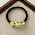 Elastic black hair tie with three polished gold spherical beads in varying sizes - Triple Sphere Gold