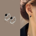 Silver hoop earrings with black heart charms shown on model and in static view - Silver Framed Black Heart Earrings(ED1887)