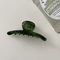 Detailed view of an elegant emerald green acetate hair claw clip with a glossy jade-like texture - One-word Shape