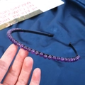 Detail of handmade black headband featuring 6mm crystal beads in polished purple finish - 6mm Amethyst