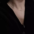 Close-up of S925 sterling silver Y-shaped necklace with polished beads on model - 45cm / Silver
