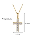 Macro shot of gold cross necklace with square cubic zirconia and dimensions 4.4x2.2cm - Gold