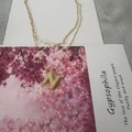 Golden double layer necklace featuring a paperclip chain and bubble letter N pendant - Letter N