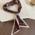 Detail of silk scarf necklace featuring paisley patterns and a heart-shaped buckle fastener - Dark Coffee Paisley