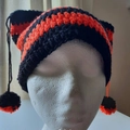 Handmade crochet cat ear hat with black and orange stripes and dangling pom-poms - Black Red Black