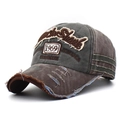 Close-up of vintage washed baseball cap with 1969 embroidery and distressed details - Coffee Brim with Coffee Top