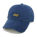 Close-up of distressed brim details and yellow .okey! embroidery on navy baseball cap - Navy Blue