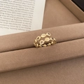 Macro detail of golden triple-layer ring with sparkling zircon and geometric circles - Double Row Round Plate Zircon Design / Gold