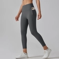 Dark grey high-waisted yoga leggings with functional side pocket showing phone storage - Graphite Grey
