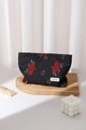 Detailed close-up of a black makeup bag with vintage red rose jacquard on a wooden stand - Red Large