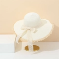 Chic cream-colored straw sun hat with lace bow and fringe edge on a golden stand - M (56-58cm) / Cream