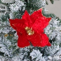 Sparkling red velvet Christmas poinsettia flower with gold glitter on snowy tree - Red