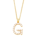 Detail of gold letter G pendant with inlaid pearls on a delicate necklace chain - Letter G