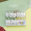 Five pieces of white bow-shaped party candles in a transparent gift box packaging - White Bowknot Candle