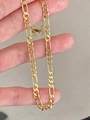 Detail shot of a golden Figaro link necklace showing the classic chain structure - Gold NK Wide Flat Chain