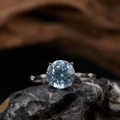 S925 sterling silver ring featuring a round blue gemstone and side accent stones - Topaz Round Cut Style (LR349)