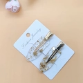 Detalle de dos pinzas para el cabello de resina con láminas de oro y clips de metal dorado - Pan de oro 1 par
