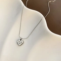 Detailed close-up of a silver heart pendant featuring four-pointed star engravings on a fine chain - 01-H14 Titanium Steel Heart Necklace Silver