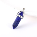 Polished dark blue hexagonal stone pendant with silver metal clasp on white base - Lapis Lazuli
