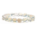 Macro shot of irregular milky white opal stone beads on a minimalist stretch bracelet - Opal