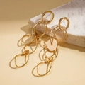 Gros plan détaillé de boucles d'oreilles géométriques dorées sur support en pierre - Or (Tige de boucle d'oreille en argent sterling 925)