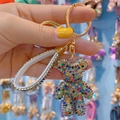 Charming multicolor rhinestone bear keychain with gold clasp and white leather wrist strap - Colorful