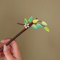 Detail of wooden hair stick with green leaf gems and white pearl flower accents - Pearl Yellow Leaf (S397)