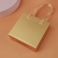 Golden luxury square jewelry gift bag with champagne satin handle and gold foil lettering - Gold