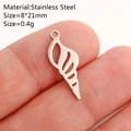 Silver stainless steel seashell pendant accessory shown on a finger for scale - Shell / Silver
