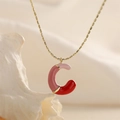 Detail of pink and red enamel letter C pendant on a gold chain necklace for women - Style-C