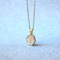 Golden hexagon necklace featuring white shell inlay and letter K on a delicate chain - Letter K