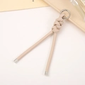 Detail of beige braided PU leather keychain with silver metal ring and knotted design - Off White