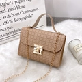 Chic beige crossbody bag with checkered texture and gold chain on plush white rug - Apricot Grid