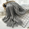 Grey crinkled scarf with fringed edges displayed on a rustic metal rack and basket - Light Gray