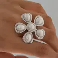 Statement silver flower ring with white pearls for women on model's hand - Retro Floral Pearl Style (PB767)