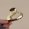 Elegant gold metal hair claw clip featuring a unique irregular hollow heart design - Irregular Ball / Gold