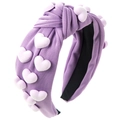 Primer plano de una diadema morada con nudo, tela texturizada y detalles de corazones 3D - Morado