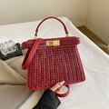 Elegant red woven leather handbag with golden twist lock and detachable crossbody strap - Red