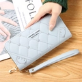 Light blue long quilted wallet for women with heart embroidery and a wristlet strap - Blue