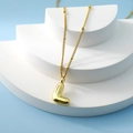 Minimalist gold bubble necklace with 3D letter L pendant on a clean white display stand - Letter L(L)