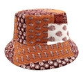 Detail of bohemian patchwork floral prints and quilted stitching on a reversible bucket hat - M (56-58cm) / Orange