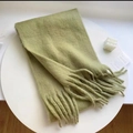 Thick light green knitted plaid scarf with long tassels in a minimalist setting - Solid Matcha Green