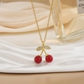 Elegant gold chain necklace with red cherry pendant and sparkling zircon leaves on silk - Gold Red Cherry with Zirconia Leaf