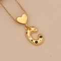 Detail of golden heart-shaped clasp and colorful zircon encrusted letter C pendant - Letter C / Gold
