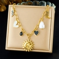 Detail of vintage sun face, pearl, and heart pendants on a gold chain necklace - Necklace (N3769)