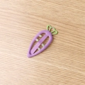 Purple carrot shaped hair clip for kids with green leaf top on wooden surface - Purple