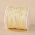 Pale yellow 0.8mm nylon cord on white spool for DIY jewelry weaving projects - Off-white