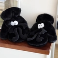 Close-up of black soot sprite plush slippers with large eyes on wooden steps - Quirky Monster Style (Black)